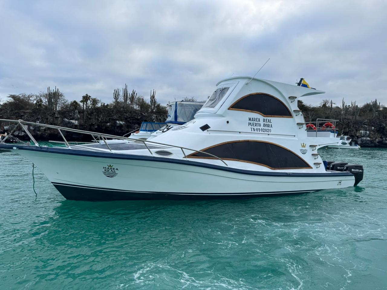 The Marea Real anchored in turquoise water off the coast