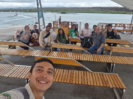 Guide and travelers smiling on the dock before heading back