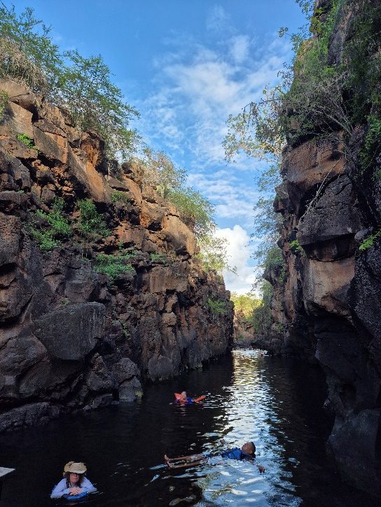 Crystal-clear water between the tall rock walls of Las Grietas