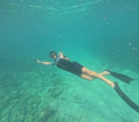 Traveler snorkeling in crystal-clear water