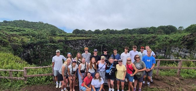 Group of travelers in front of one of the Los Gemelos craters